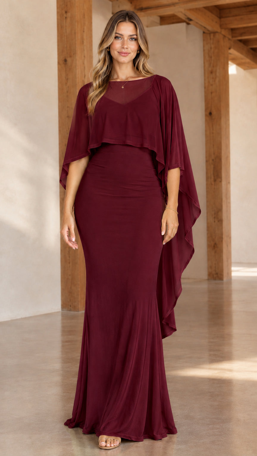 Front view of woman wearing burgundy wine sheer capelet overlay formal maxi dress
