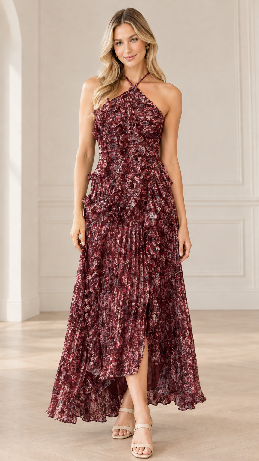 Front full-length view of model wearing burgundy floral halter neck pleated maxi dress