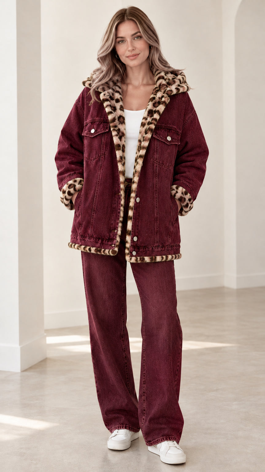 Model wearing burgundy red hooded denim jacket with leopard lining and matching wide-leg jeans