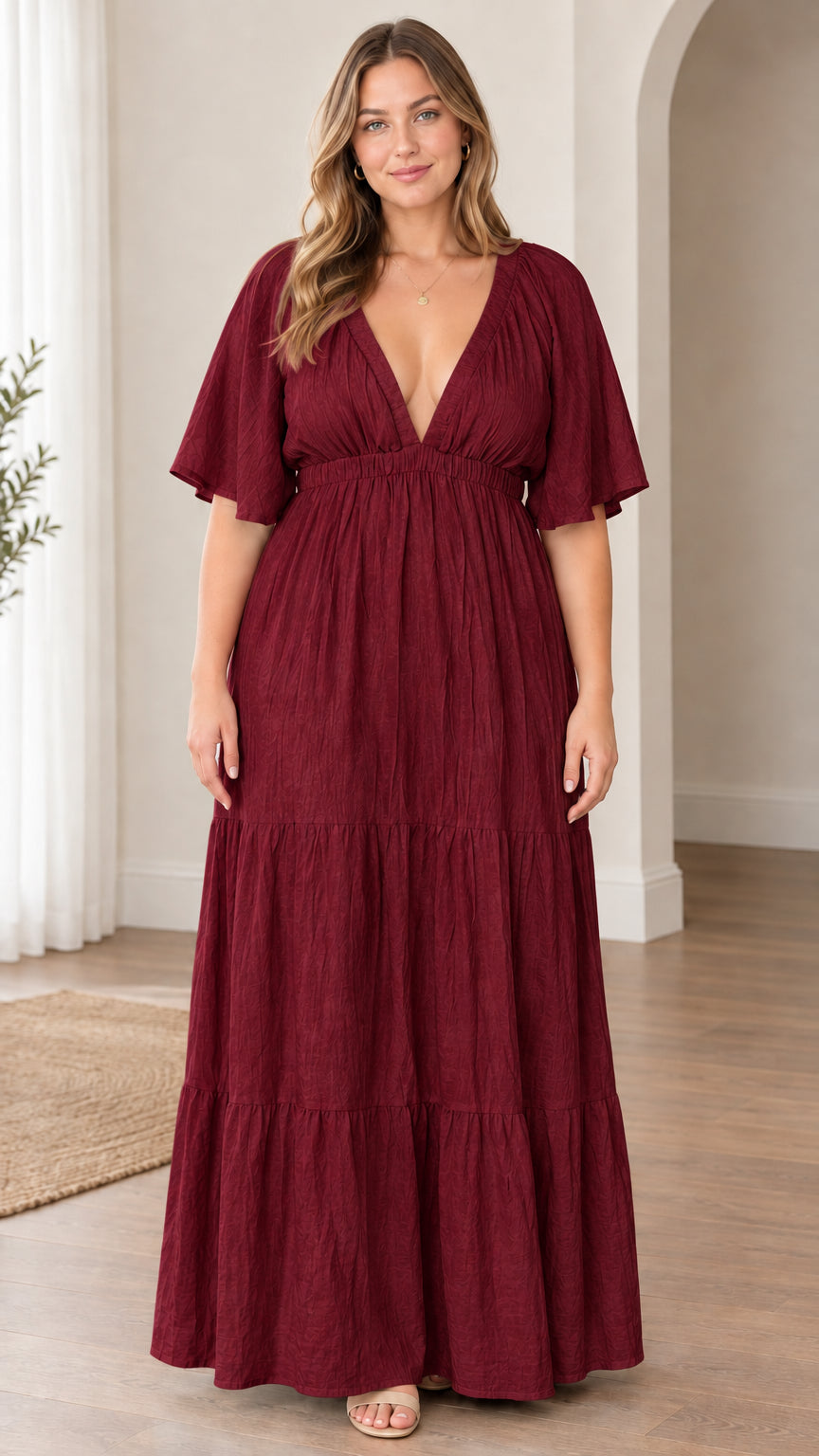 Model wearing burgundy wine plunge V-neck tiered maxi dress with flutter sleeves