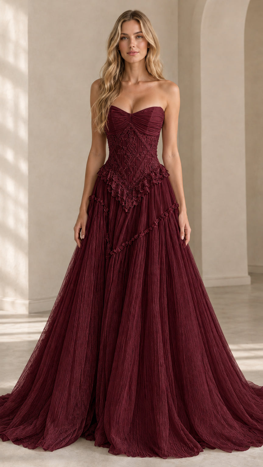Front view of model wearing burgundy strapless basque waist tulle gown