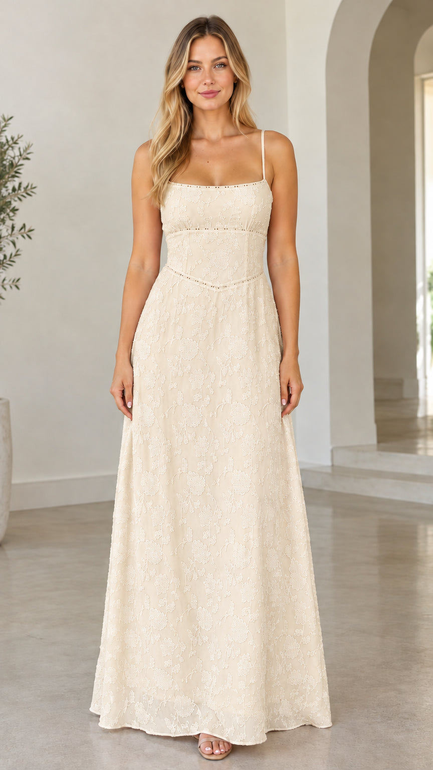 Front view of model wearing champagne cream floral jacquard tie-back maxi dress
