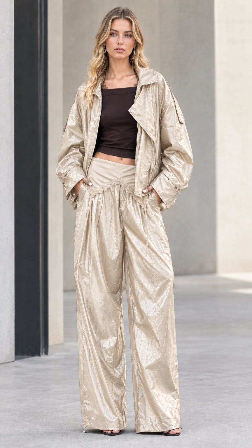 Full front view of model wearing champagne metallic crinkle jacket and wide leg pants set