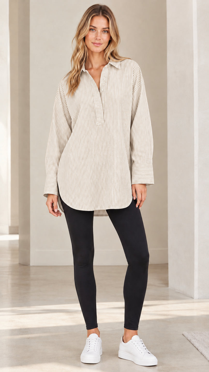 Front view of model wearing beige and white vertical striped popover tunic shirt