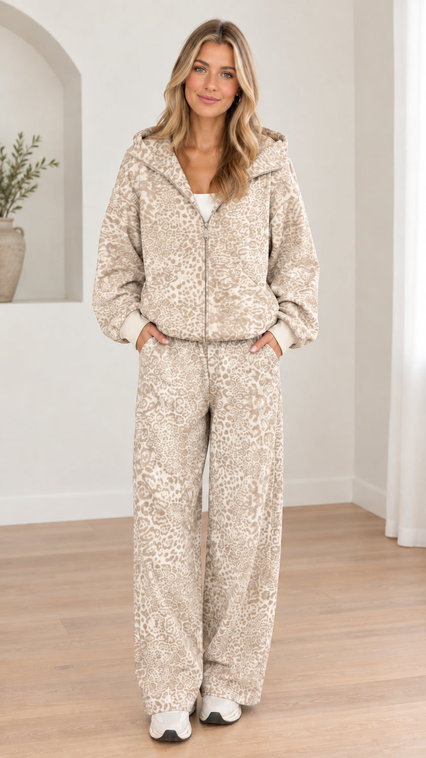 Woman wearing light beige leopard print hooded zip-up jacket and wide-leg pants set