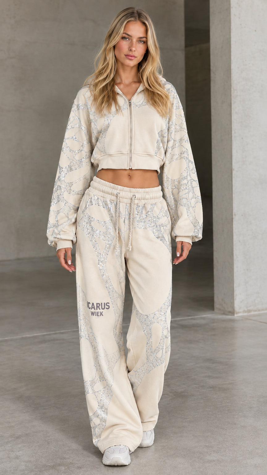 Front view of woman wearing beige cream rhinestone cropped hoodie and wide-leg sweatpants set