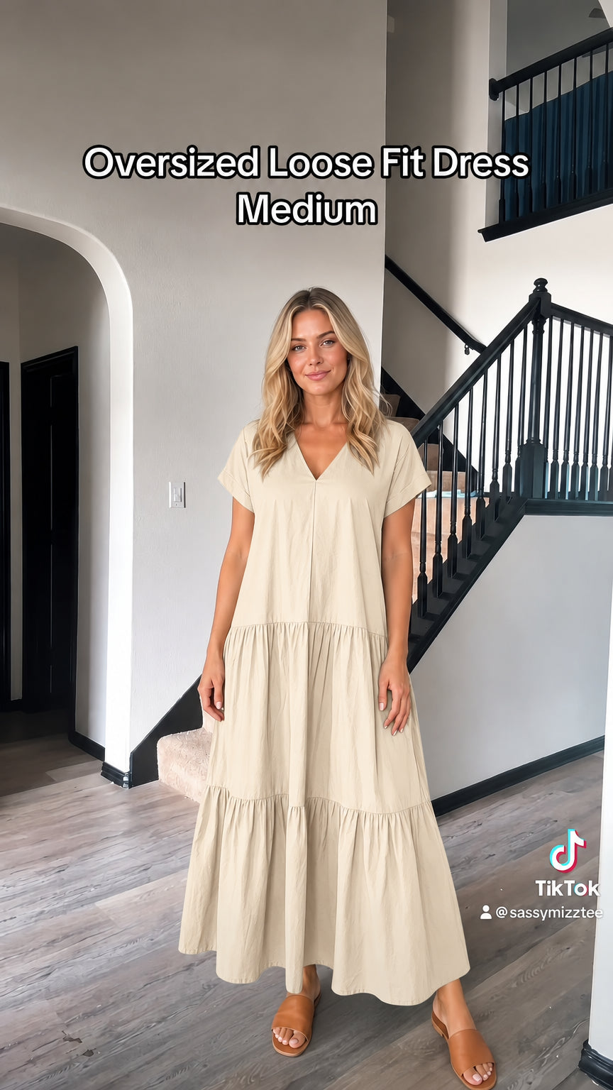 Front view of woman wearing beige cream short sleeve tiered maxi dress