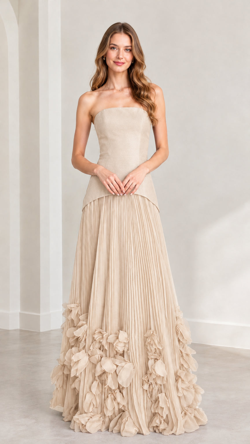 Front view of model wearing champagne beige strapless pleated maxi dress