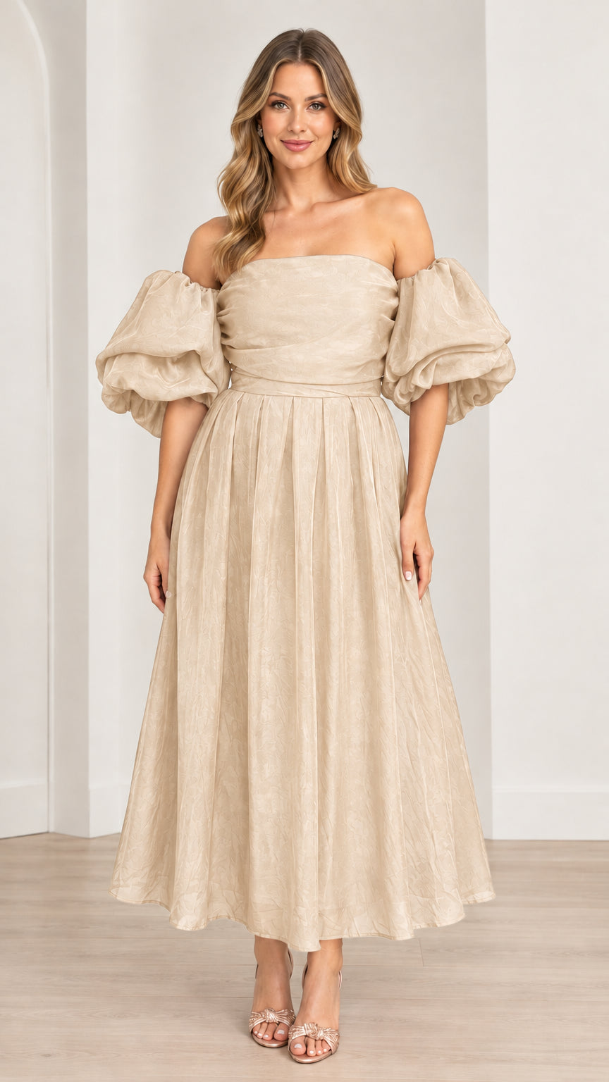 Model wearing off-the-shoulder puff sleeve pleated midi dress in champagne beige