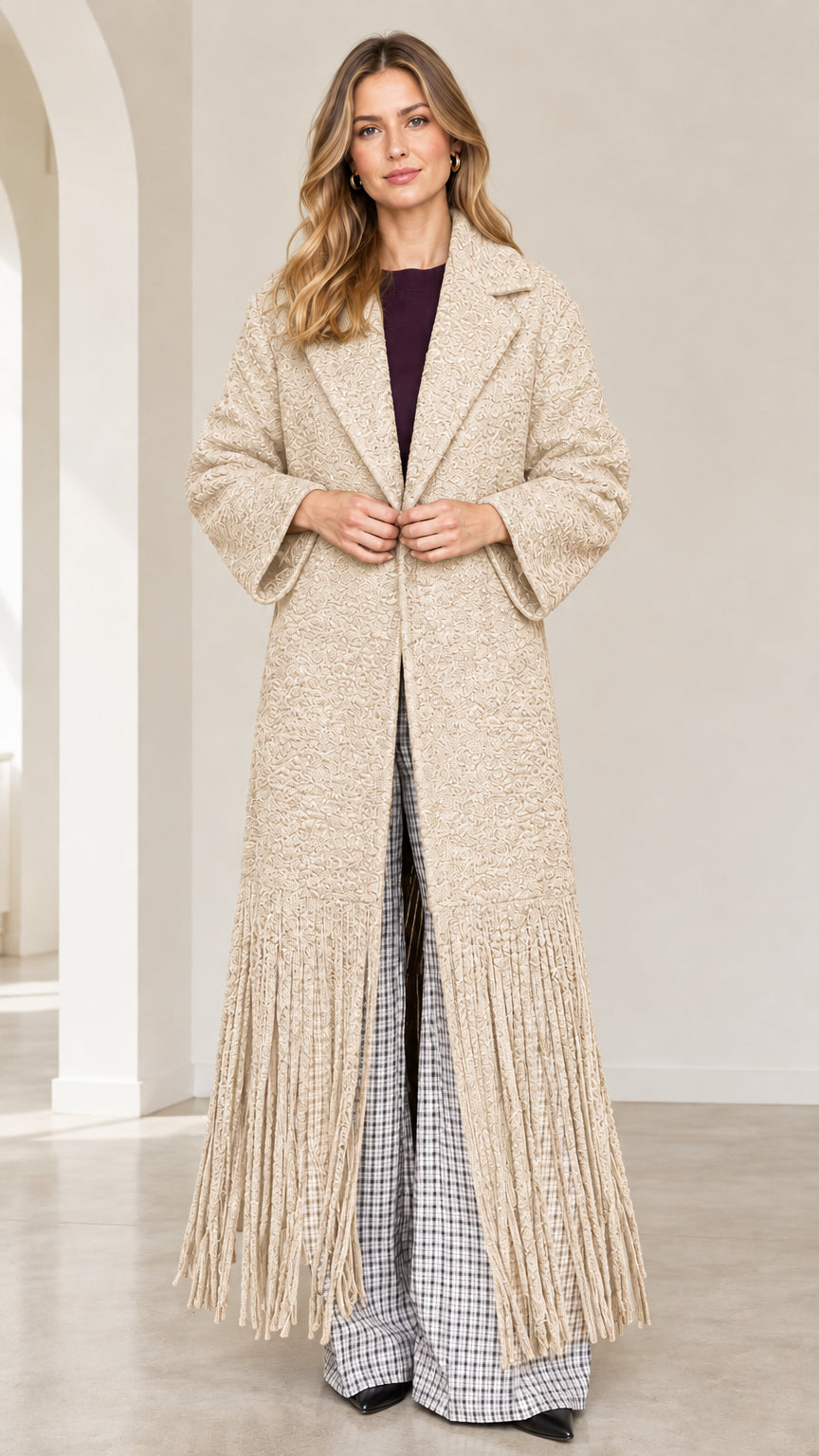 Front view of beige cream textured bouclé maxi coat with fringe trim