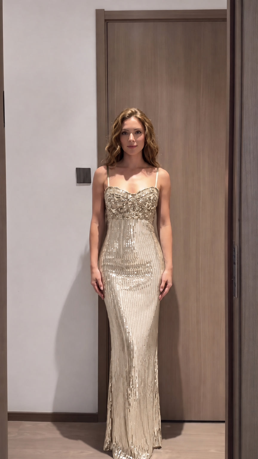 Front view of model wearing champagne gold sequin corset evening gown