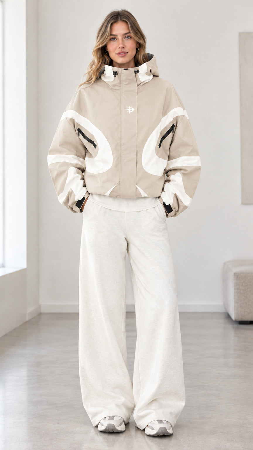 Front view of model wearing beige and white colorblock hooded jacket