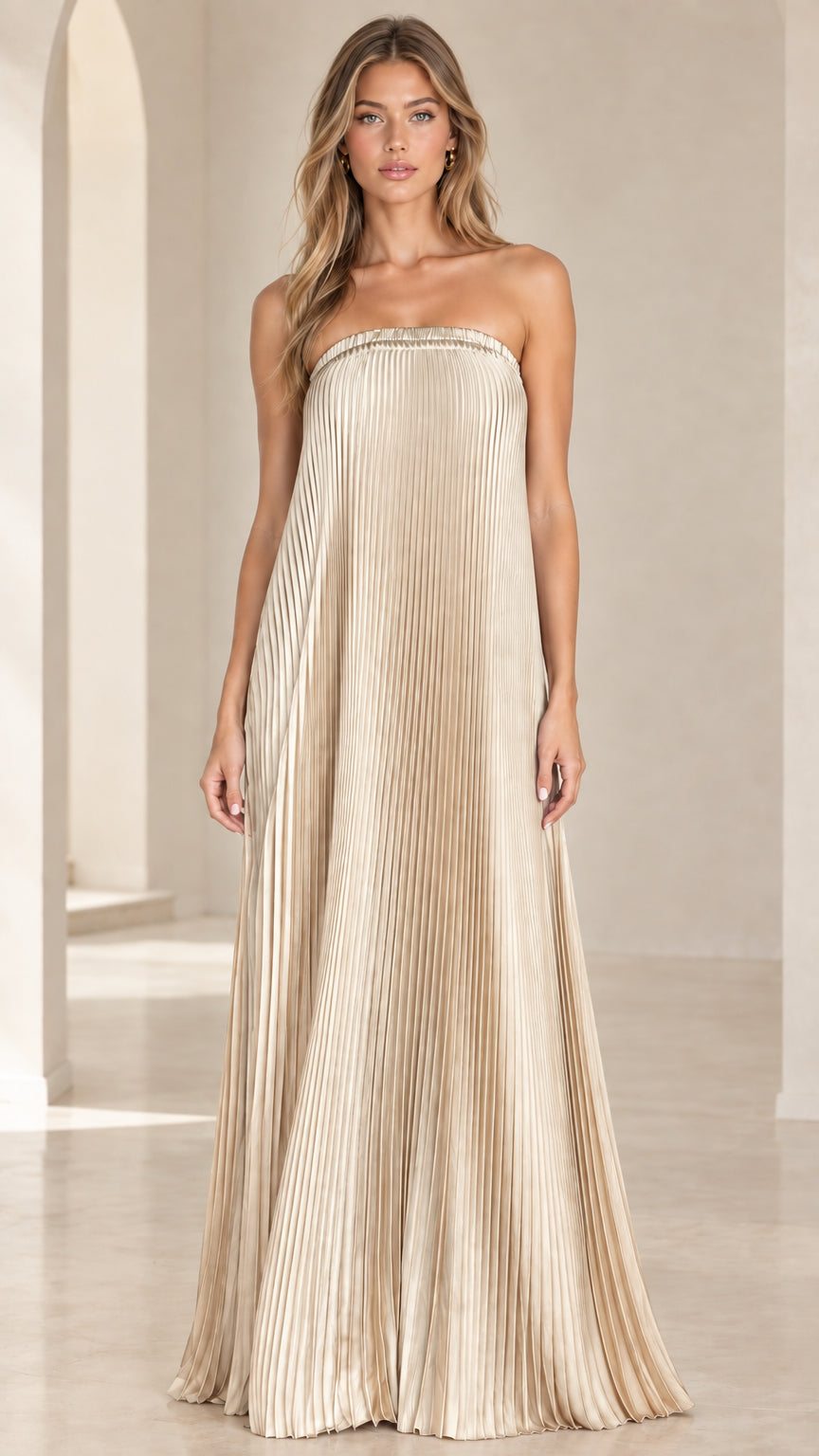 Front view of model wearing a champagne gold strapless pleated maxi dress