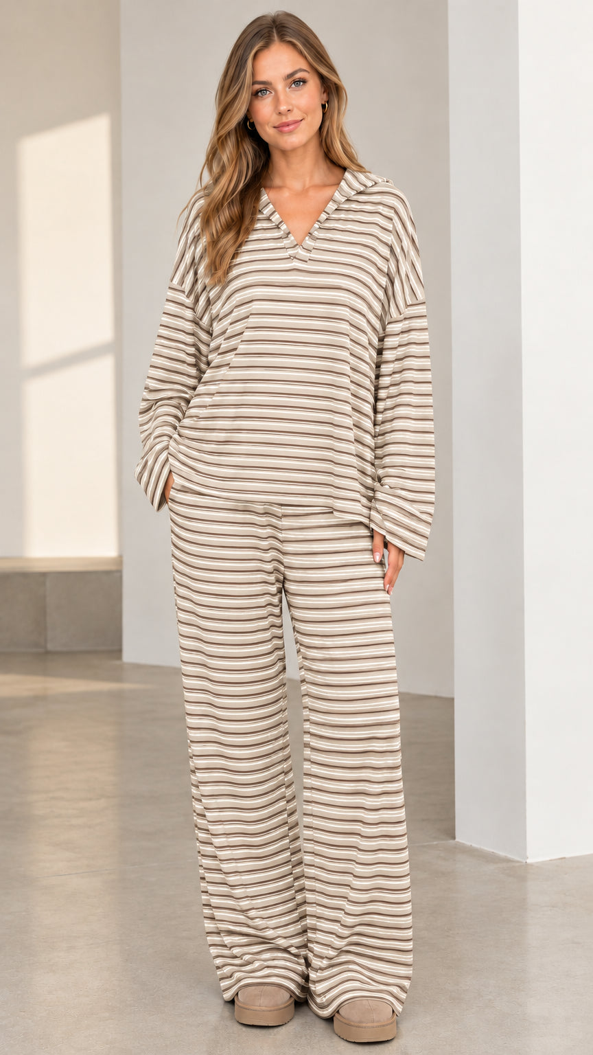 Woman wearing beige and white striped wide leg loungewear two-piece set