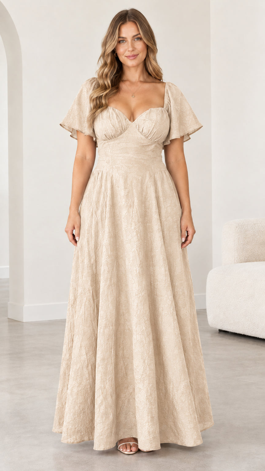 Front view of woman wearing champagne beige sweetheart flutter sleeve maxi dress