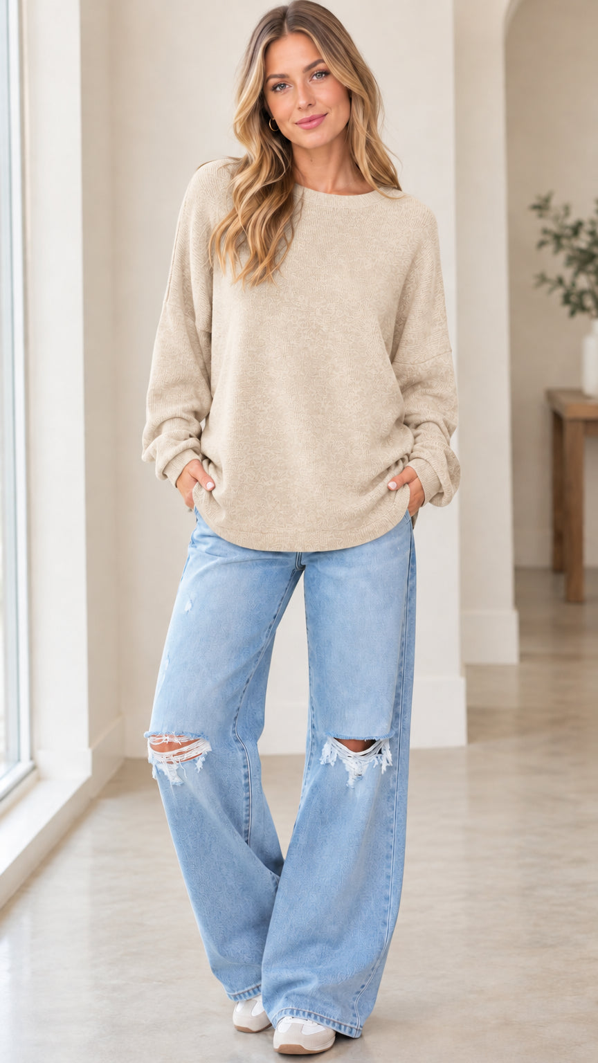 Front full view of woman wearing beige oatmeal crewneck long sleeve knit pullover sweatshirt