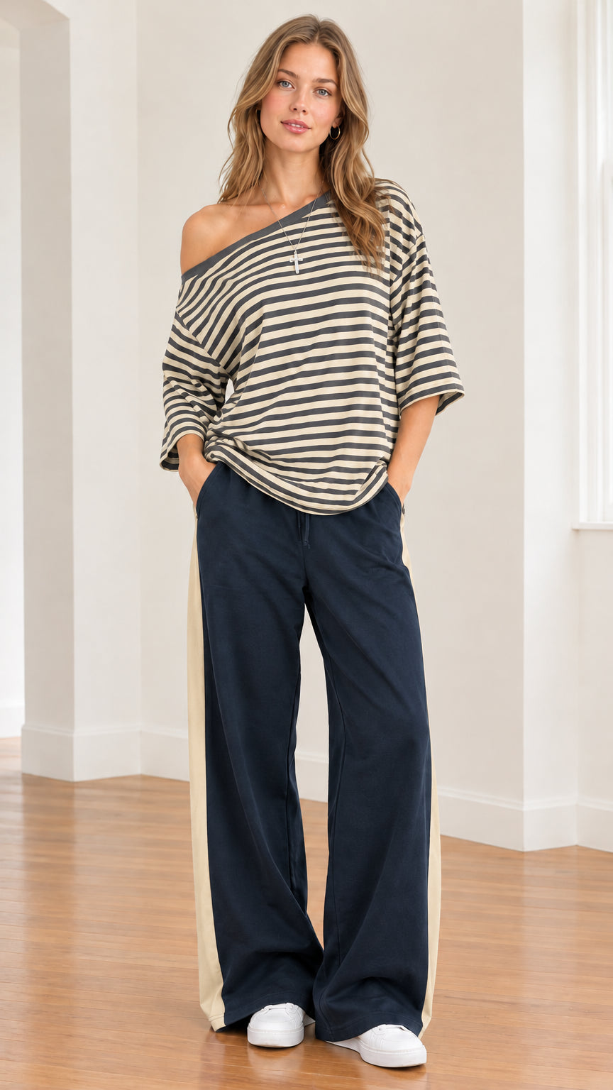 Model wearing khaki beige striped one-shoulder top with complementary side-stripe wide-leg pants