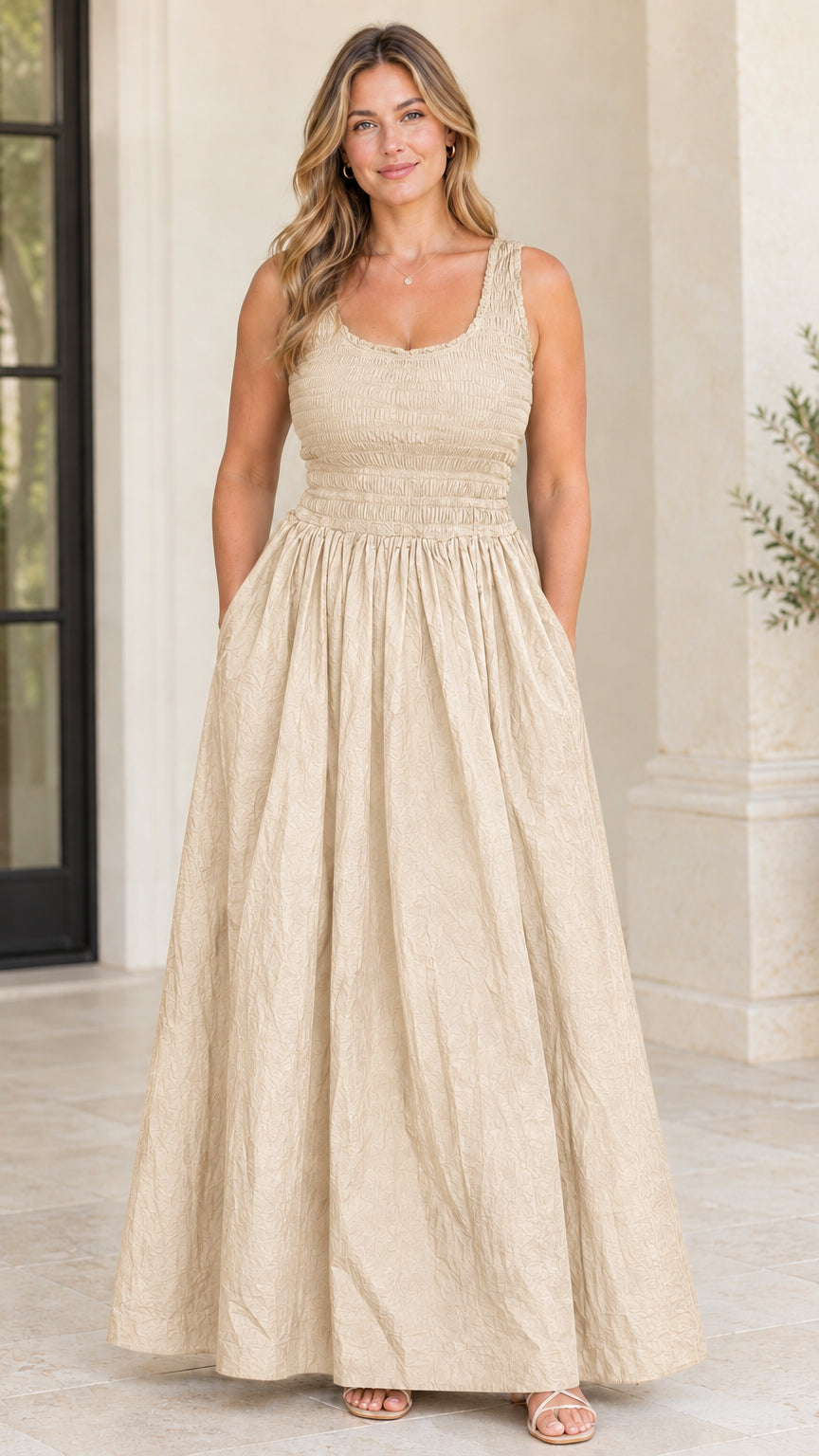 Model wearing beige cream sleeveless smocked bodice maxi dress with pockets